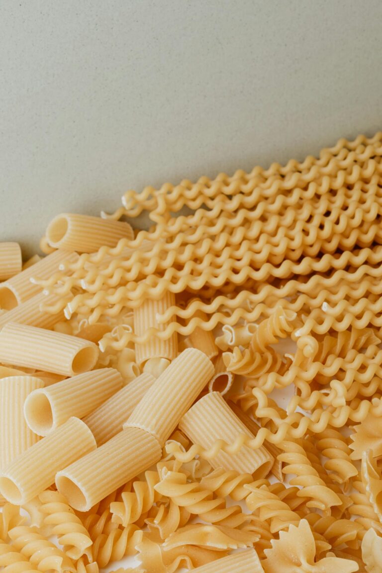 Close-up image of assorted uncooked pasta varieties. Perfect for food and culinary content.